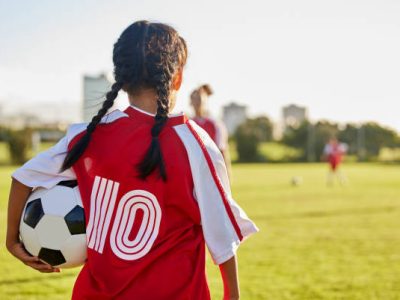 Children, sport and football with a girl soccer player on a field outdoor for fitness, exercise or training. Sports, workout and kids with a female child on grass for health, wellness and recreation