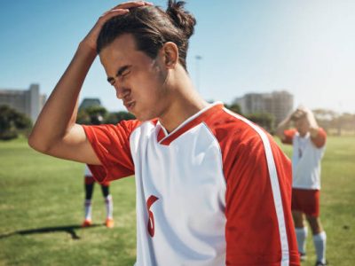 Sport fail, soccer team loss and athlete angry about sports game results on a outdoor field. Football, soccer player and teamwork after exercise, workout and training for fitness and cardio together